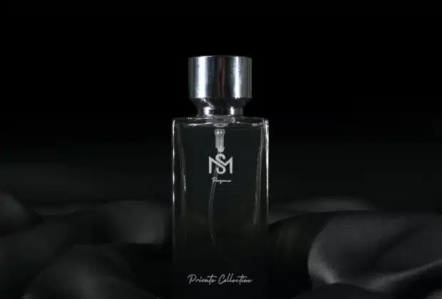 a bottle of perfume sitting on top of a black cloth